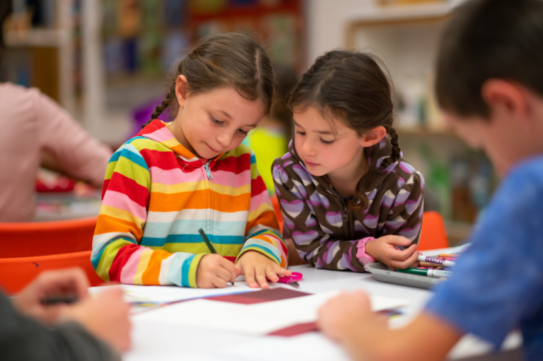 Children drawing at a table