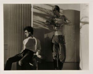 Standing and Seated Figures in Sunlight and Palm Shadows