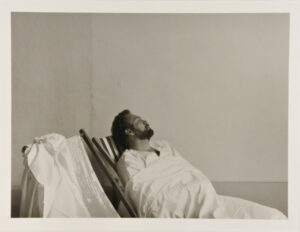 Figure Seated in Striped Lawn Chair