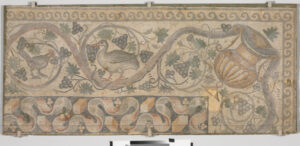 Fragment of floor mosaic depicting a scrolling vine and birds