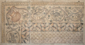 Fragment of floor mosaic depicting a scrolling vine and birds