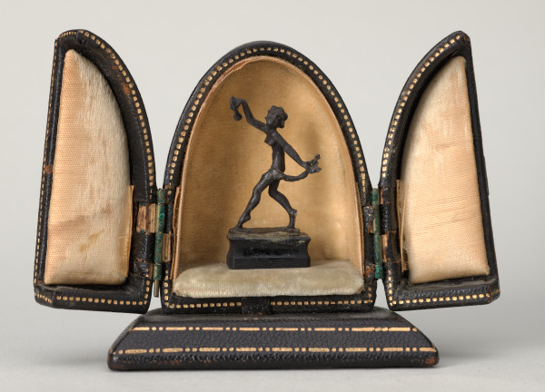 MYTHOLOGICAL FEMALE FIGURE IN A BLACK LEATHER CASE
