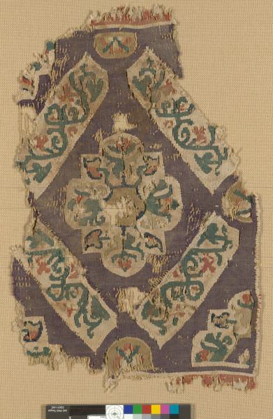 FRAGMENT OF A DECORATIVE BAND WITH FLORAL MEDALLION IN DIAMOND GRID