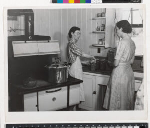 Mrs. Clarence N. Pace Canning English Peas in her Pressure Cooker, with Louise Martin, the Home Management Supervisor, Helping; Transylvania Project, Louisiana, June 1940