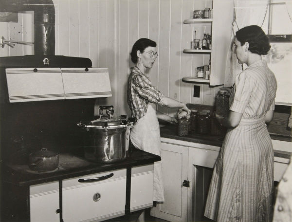 Mrs. Clarence N. Pace Canning English Peas in her Pressure Cooker, with Louise Martin, the Home Management Supervisor, Helping; Transylvania Project, Louisiana, June 1940 - Image 2
