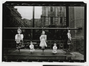 Dolls Hanging on Fence