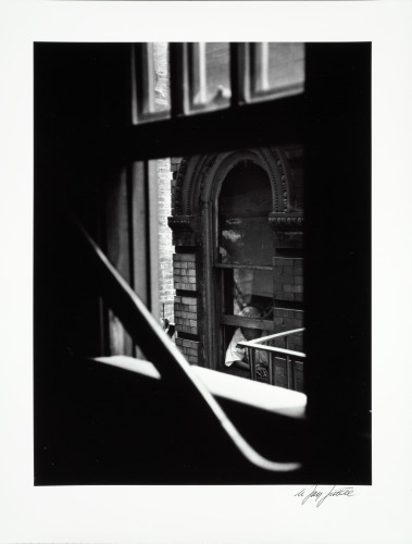 WOMAN LOOKING OUT OF WINDOW