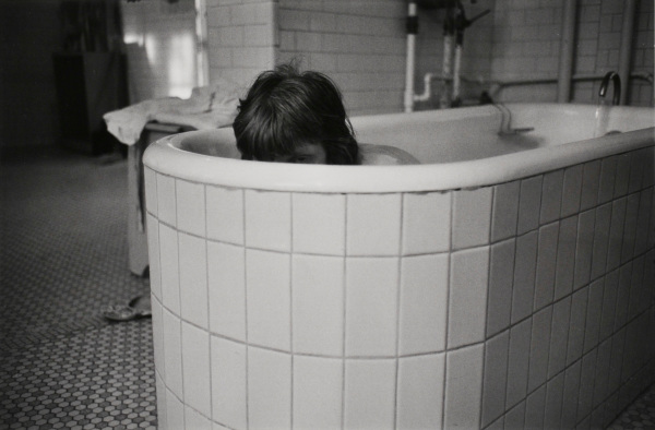 MARY FRANCES PEEKING FROM TUB, WARD 81, OREGON STATE HOSPITAL, SALEM, OREGON