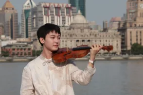 Violinist Wei Zhu, holding a violin