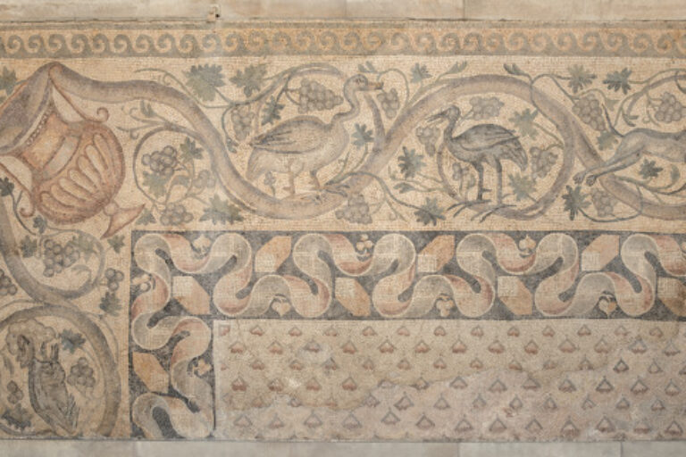Fragment of floor mosaic depicting a scrolling vine and birds