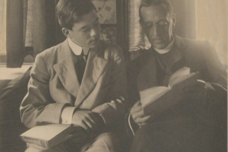 MAN AND BOY IN FRONT OF CLOCK