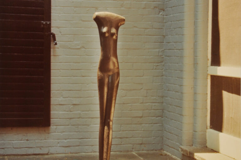 GIACOMETTI, HEADLEES FIGURE OF A YOUNG GIRL. PHOTOGRAPH TAKEN IN THE WURTZBURGER SCULPTURE GARDEN (ORIGINAL SITE, TIMBERLANE)
