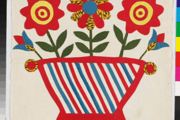 FLOWERS IN RED AND BLUE BASKET