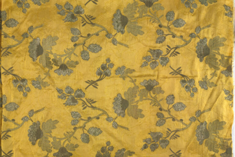 METALLIC BROCADE WITH ASYMMETRICAL FLORAL DESIGN