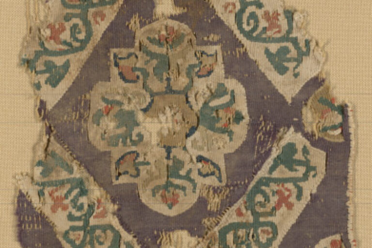 FRAGMENT OF A DECORATIVE BAND WITH FLORAL MEDALLION IN DIAMOND GRID