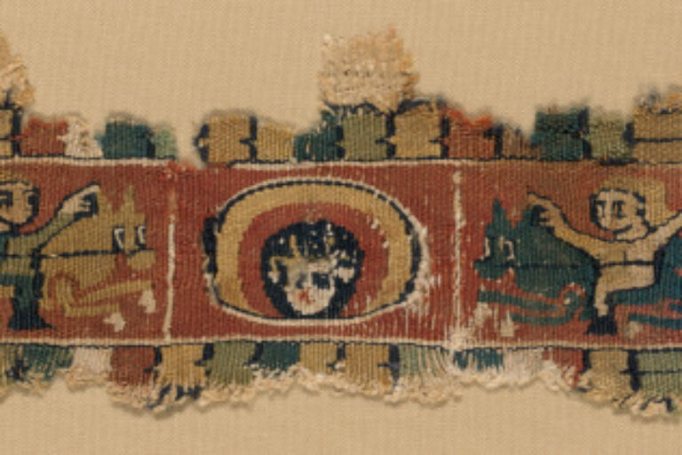 FRAGMENT OF BAND OR CLAVUS WITH SAINT’S HEAD FLANKED BY HORSEMEN