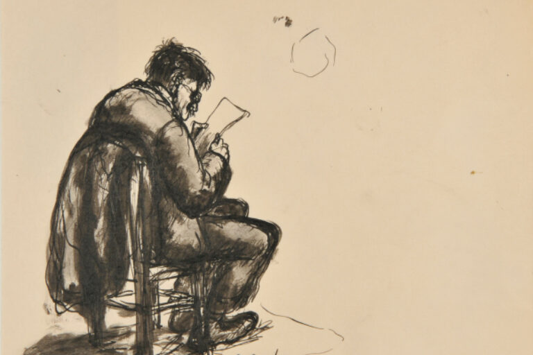 MAN SITTING IN CHAIR READING