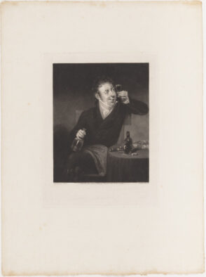 Man at Table Holding Glass of Wine to Light