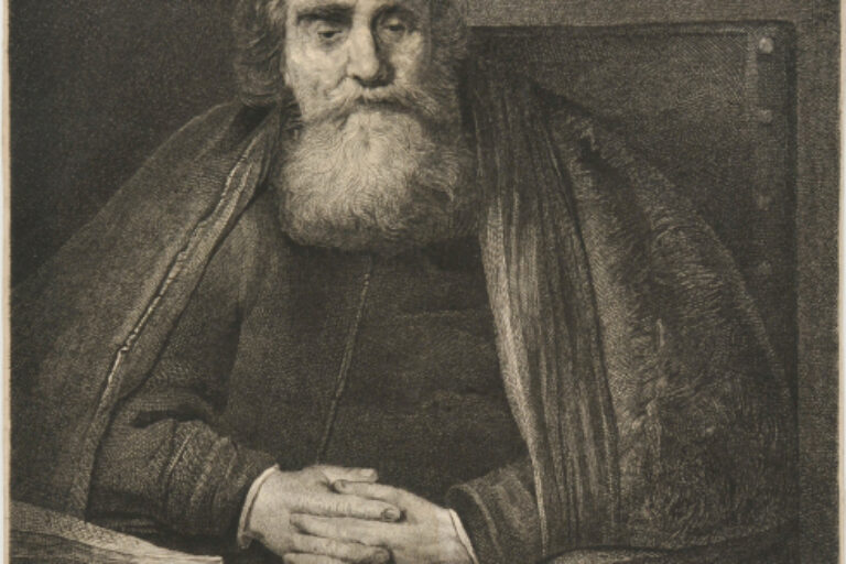 BEARDED MAN SEATED WITH HIS HANDS CLASPED