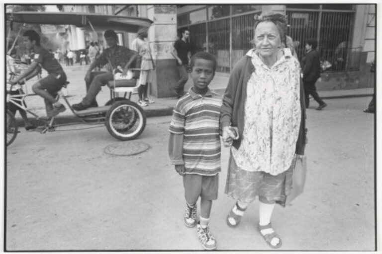OLD WOMAN AND BOY CROSSING STREET
