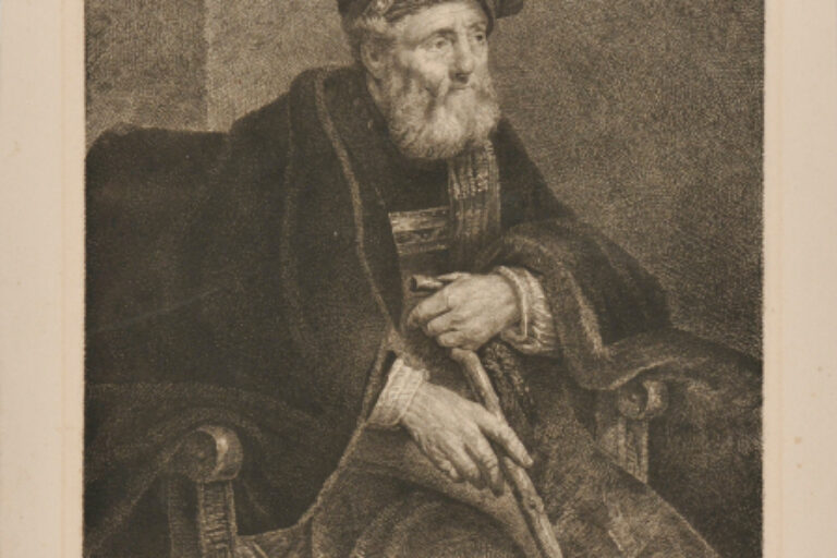 MAN WITH BEARD WEARING CLOAK AND FEATHERED HAT SEATED WITH A CANE IN HIS HAND