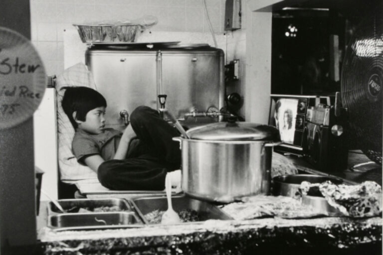 BOY IN KITCHEN WATCHING TV