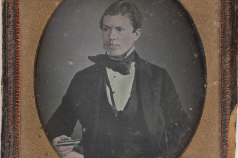 MAN HOLDING DAGUERREOTYPE