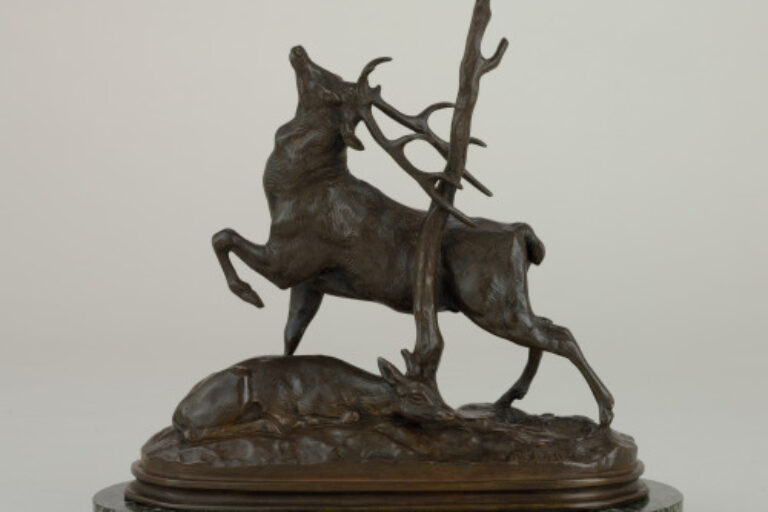 DEER RUBBING ITS ANTLERS AGAINST A TREE