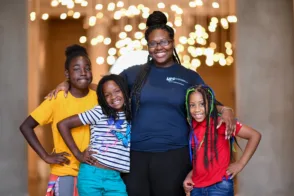 A family smiles for a group photo at the Baltimore Museum of Art.